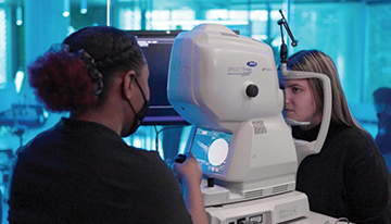 Doctor and Patient using Topcon Triton machine for eye exam